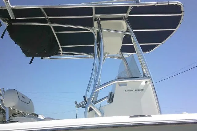 Slide: The Image of 2015 Sea Hunt Ultra 225 boat with T-top against clear blue sky. - 51
