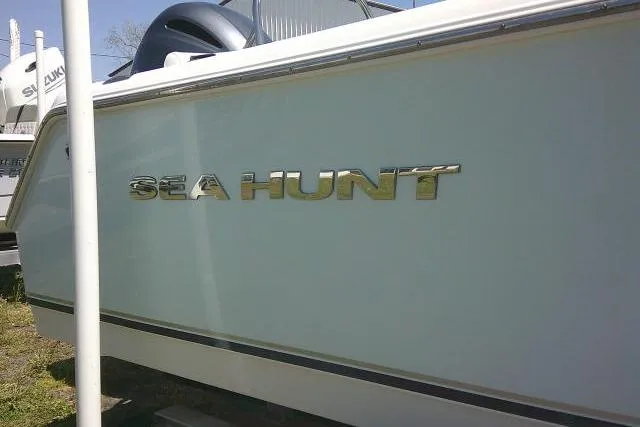 Slide: The Image of 2015 Sea Hunt Ultra 225 boat side view with logo. - 53