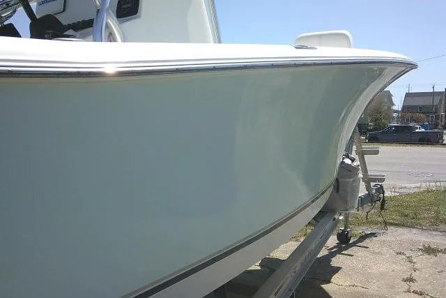 Slide: The Image of 2015 Sea Hunt Ultra 225 boat on trailer, side view in outdoor setting. - 54