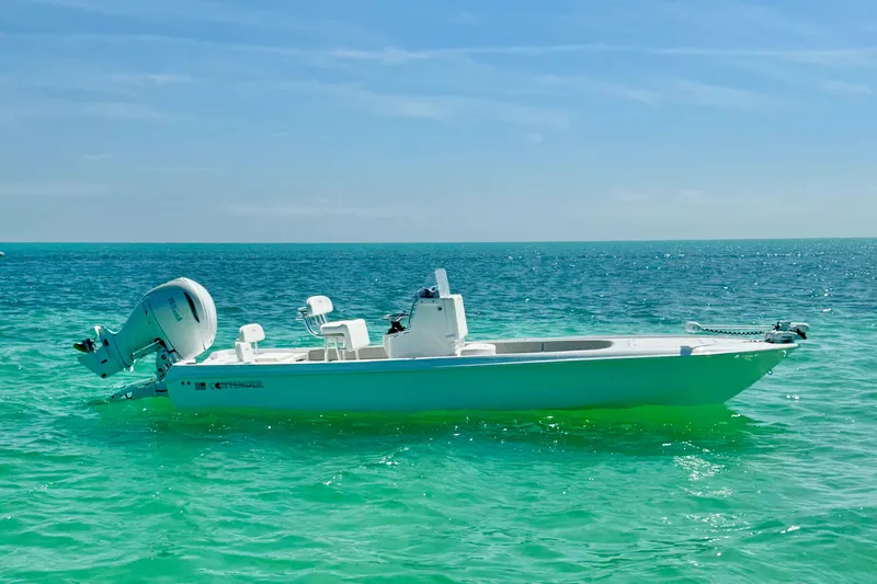 The Image of 2025 Contender 26 Bay boat on clear turquoise water under blue sky. - 0