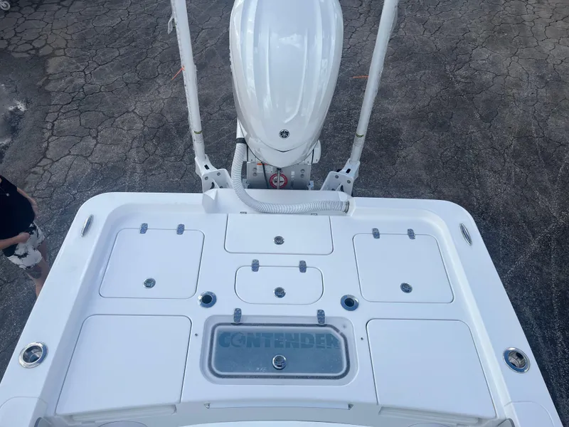 Slide: The Image of 2025 Contender 26 Bay boat deck with storage compartments and motor, viewed from above. - 7