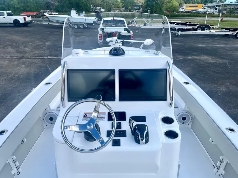 Slide: The Image of 2025 Contender 26 Bay boat dashboard with dual screens and steering wheel. - 8