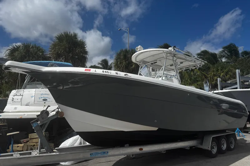 The Image of 2008 Sea Fox 287 Center Console boat on trailer, parked outdoors under a blue sky. - 0