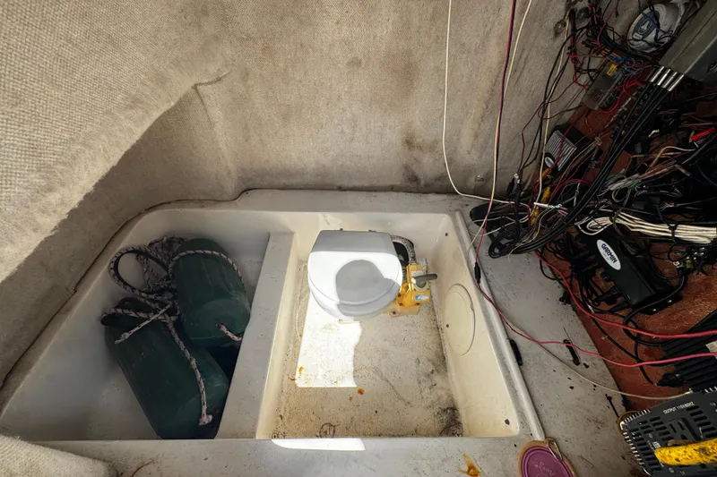 Slide: The Image of 2008 Sea Fox 287 CC boat interior with toilet, ropes, and wiring. - 18