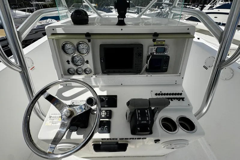 Slide: The Image of 2008 Sea Fox 287 CC boat dashboard with steering wheel, gauges, and navigation equipment. - 9