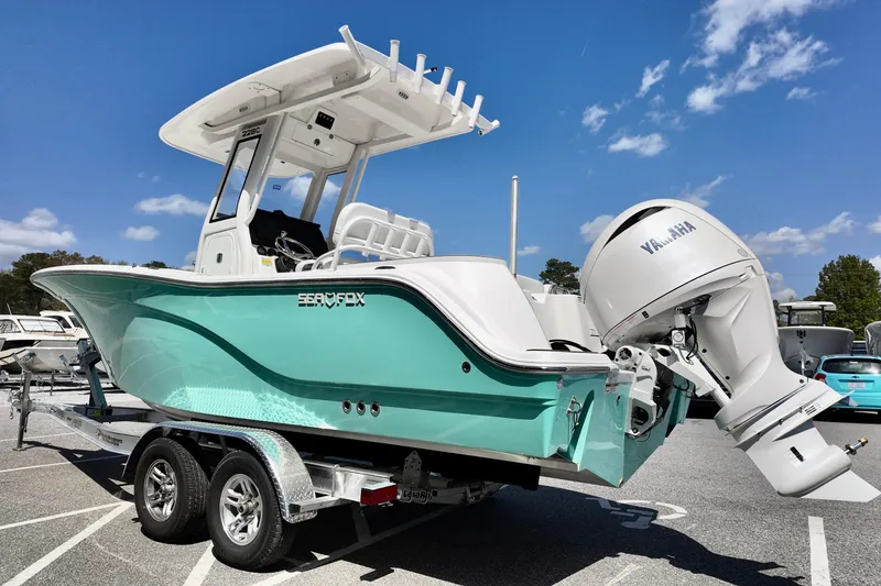 Slide: The Image of 2026 Sea Fox 228 Commander boat with Yamaha engine on trailer, under clear blue sky. - 1