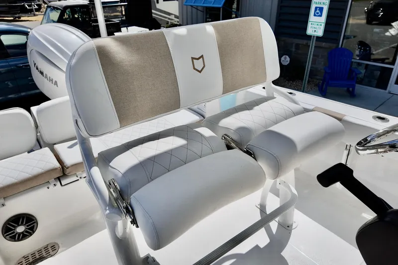 Slide: The Image of 2026 Sea Fox 228 Commander boat interior with cushioned seating and steering wheel. - 11