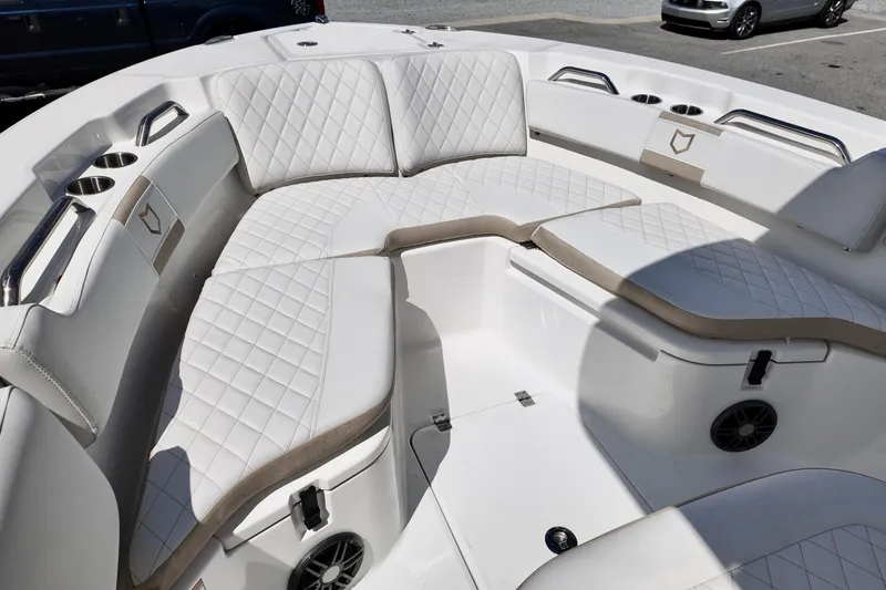 Slide: The Image of 2026 Sea Fox 228 Commander boat interior with white quilted seating and cup holders. - 16