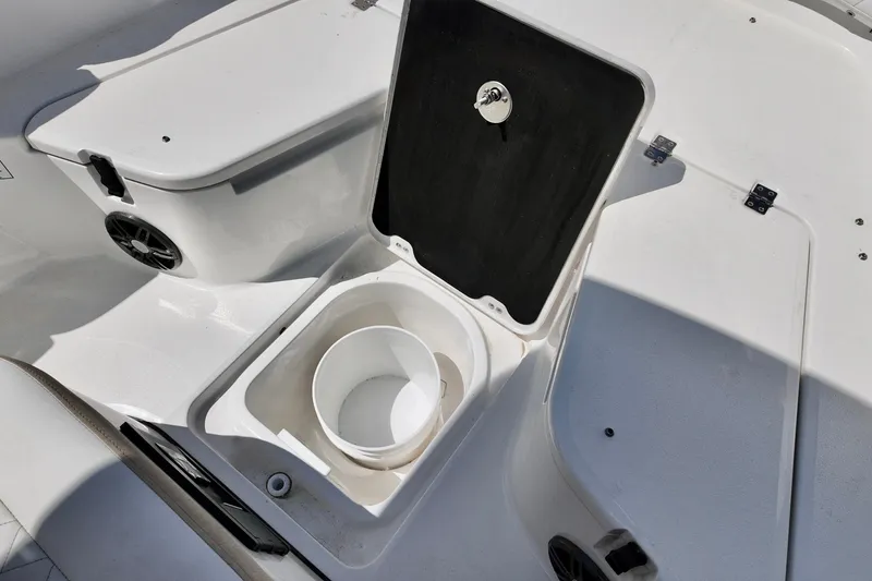 Slide: The Image of 2026 Sea Fox 228 Commander boat storage compartment with open lid and bucket inside. - 18