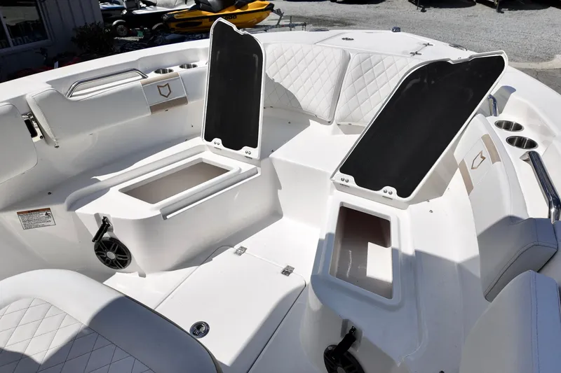 Slide: The Image of 2026 Sea Fox 228 Commander boat interior with open storage compartments and cushioned seating. - 19