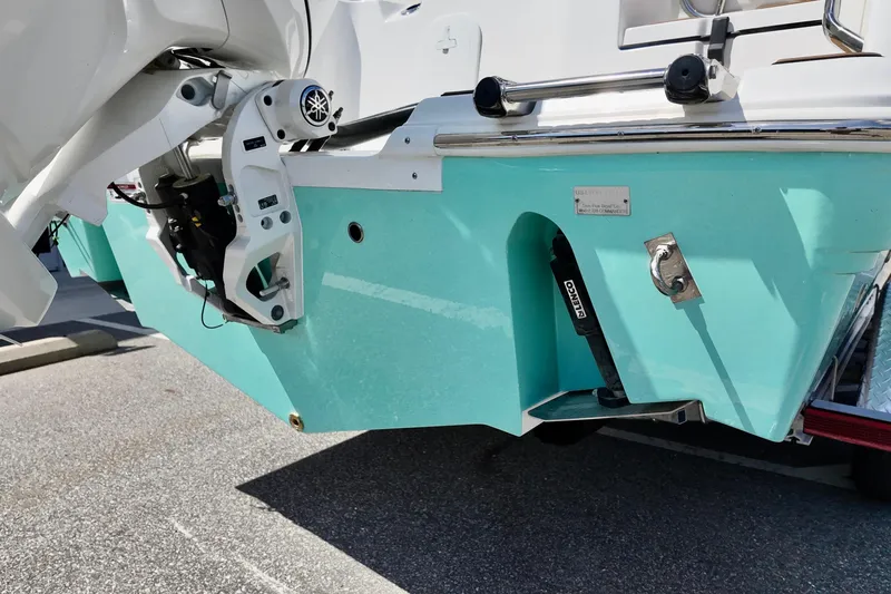 Slide: The Image of 2026 Sea Fox 228 Commander boat stern with turquoise hull and motor details. - 2