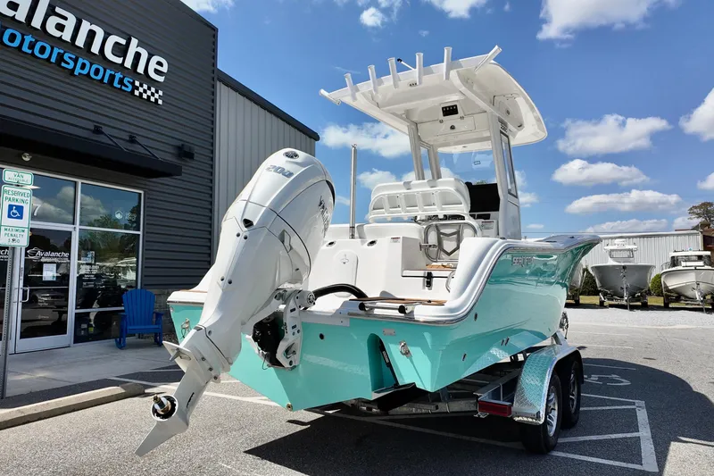 Slide: The Image of 2026 Sea Fox 228 Commander boat displayed outside dealership under blue sky. - 4