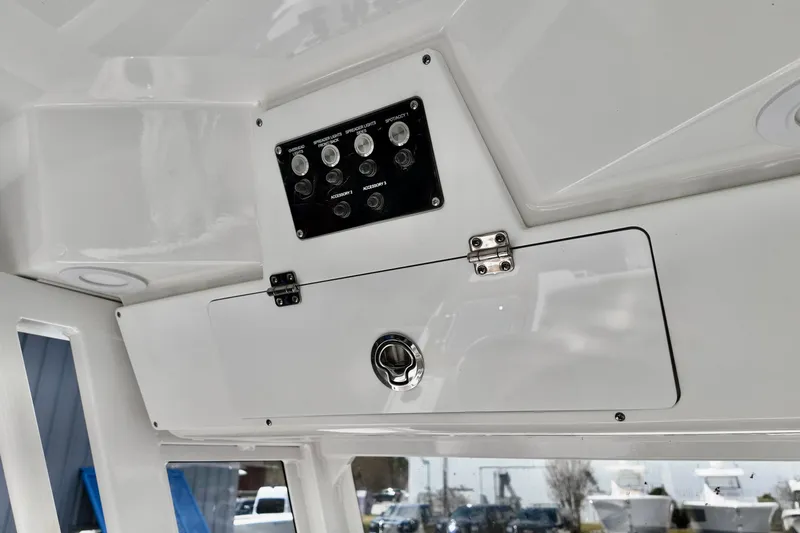 Slide: The Image of 2026 Sea Fox 228 Commander boat interior with control panel and storage compartment. - 8