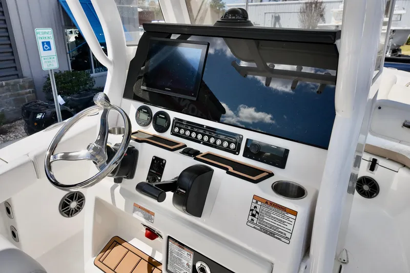 Slide: The Image of 2026 Sea Fox 228 Commander boat dashboard with steering wheel and navigation controls. - 9