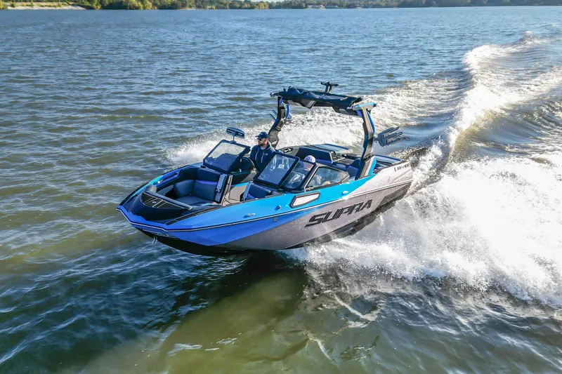 Slide: The Image of 2024 Supra SV 400 boat cruising on a lake, creating dynamic waves. - 2