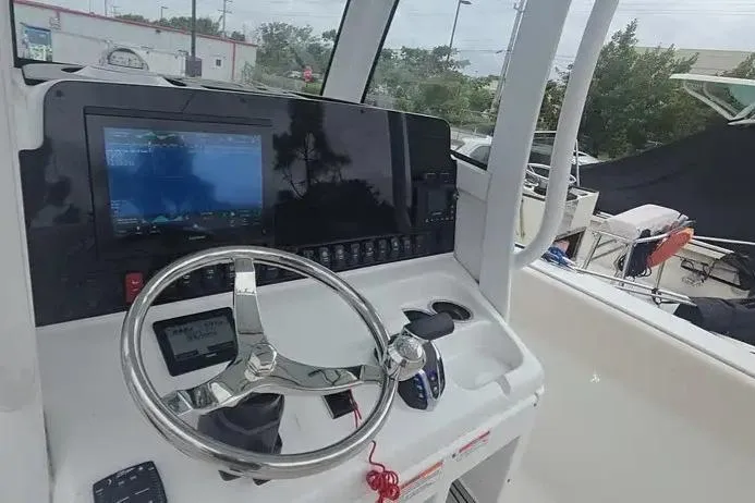 Slide: The Image of Helm of 2025 Sea Hunt Ultra 255 SE boat with modern navigation system and controls. - 10