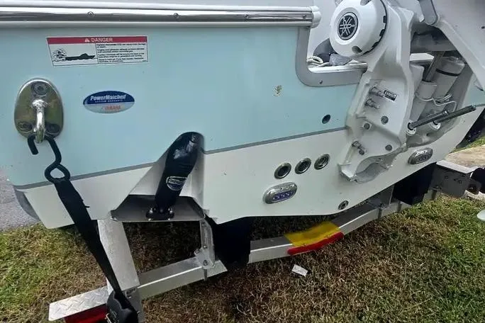 Slide: The Image of 2025 Sea Hunt Ultra 255 SE boat on trailer, rear view showing engine and hull details. - 12