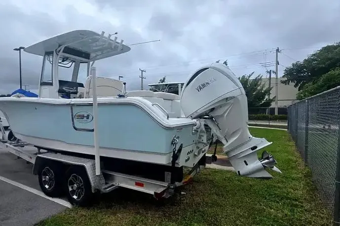 Slide: The Image of 2025 Sea Hunt Ultra 255 SE boat on trailer with Yamaha outboard motor. - 13