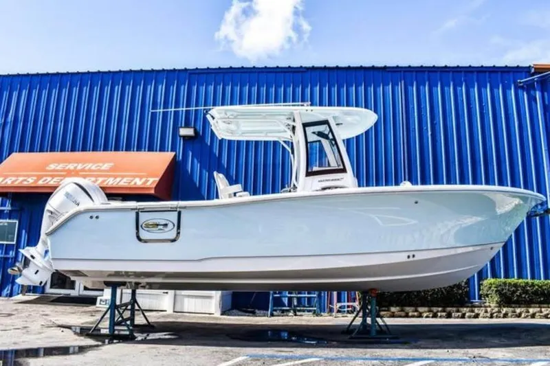 Slide: The Image of 2025 Sea Hunt Ultra 255 SE boat displayed outside service department. - 17
