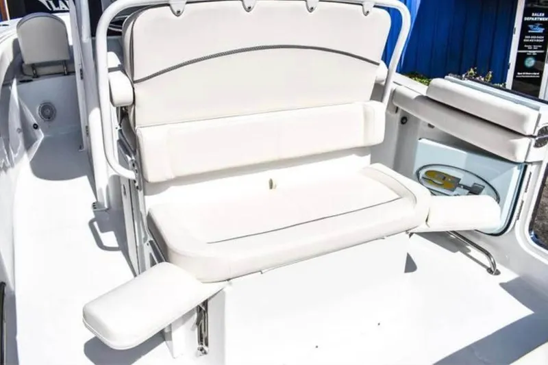 Slide: The Image of 2025 Sea Hunt Ultra 255 SE boat interior with white cushioned seating. - 19