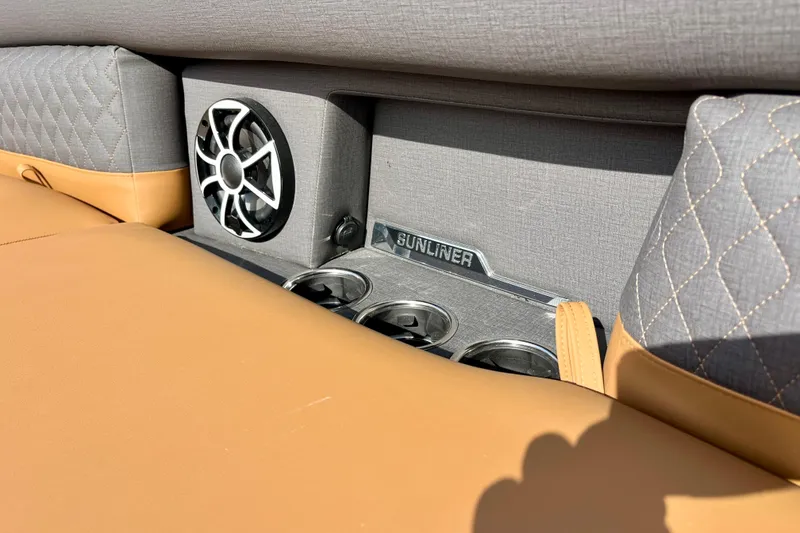 Slide: The Image of Interior of Harris Sunliner 250 boat, featuring speaker and cup holders. - 21