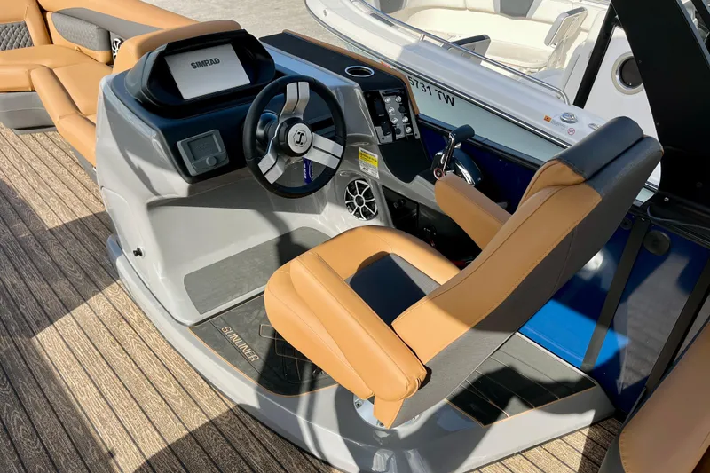 Slide: The Image of Interior of 2026 Harris Sunliner 250 boat with steering wheel and seating. - 36