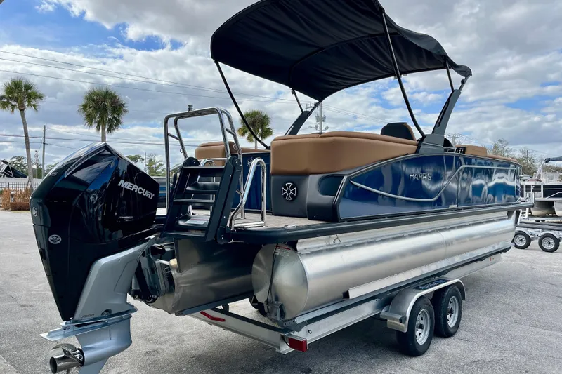 Slide: The Image of 2026 Harris Sunliner 250 pontoon boat with Mercury engine on trailer. - 5