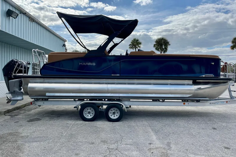 Slide: The Image of Harris Sunliner 250 pontoon boat 2026 on trailer, side view. - 9