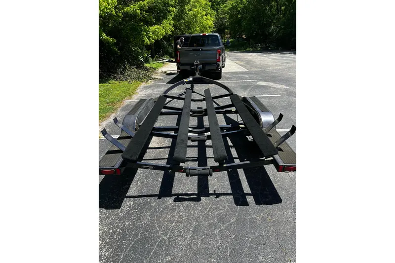 Slide: The Image of Trailer attached to a truck, parked on a sunny road, surrounded by greenery. - 8