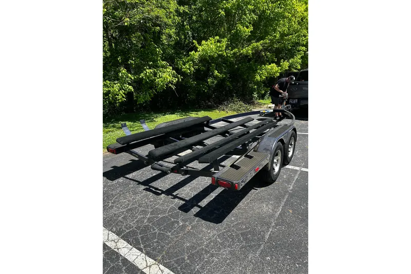 Slide: The Image of Boat trailer for Bryant 219, 2006 model, parked in a sunny lot. - 9