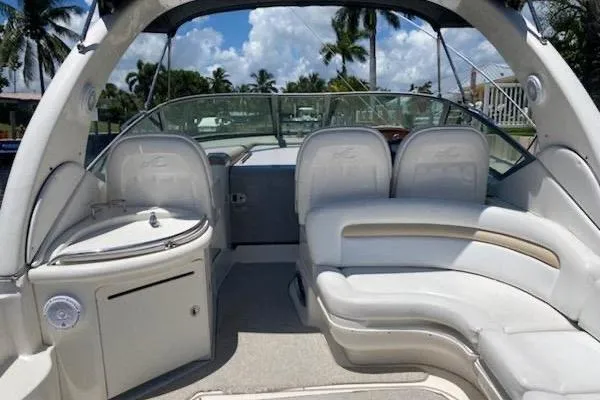 Slide: The Image of 2008 Sea Ray 340 Sundancer boat interior with white seating and outdoor view. - 2
