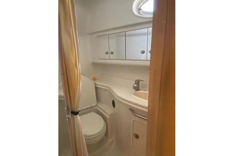 Slide: The Image of Bathroom interior of 2008 Sea Ray 340 Sundancer yacht, featuring sink and toilet. - 6