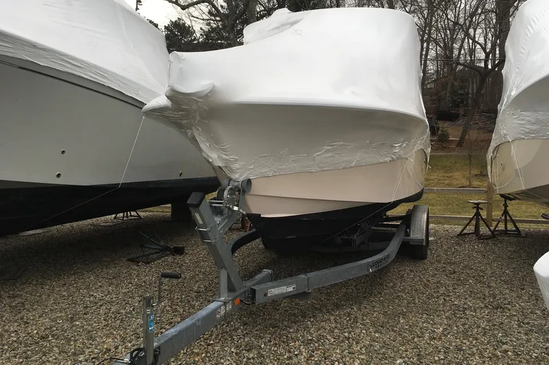 Slide: The Image of 2019 Grady-White Freedom 235 boat covered and stored on a trailer. - 16
