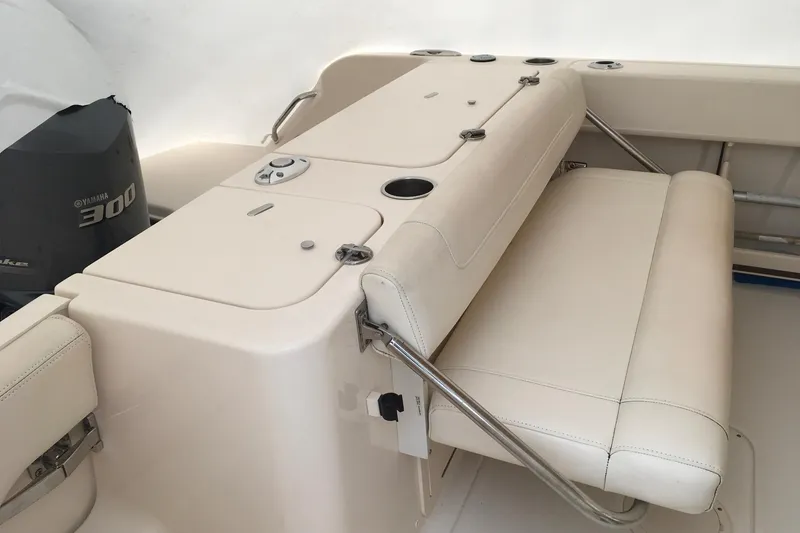 Slide: The Image of 2019 Grady-White Freedom 235 boat interior with Yamaha 300 engine, featuring beige seating. - 17