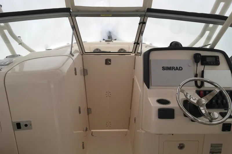 Slide: The Image of 2019 Grady-White Freedom 235 boat cockpit with Simrad navigation system. - 23
