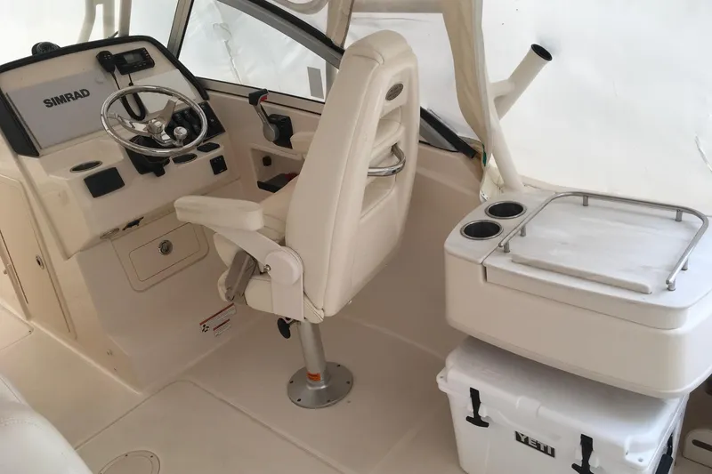 Slide: The Image of Interior of 2019 Grady-White Freedom 235 boat with helm, seat, and cooler. - 6