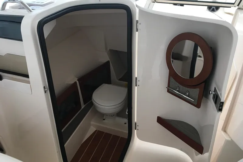 Slide: The Image of 2019 Grady-White Freedom 235 boat interior with compact bathroom and mirror. - 8