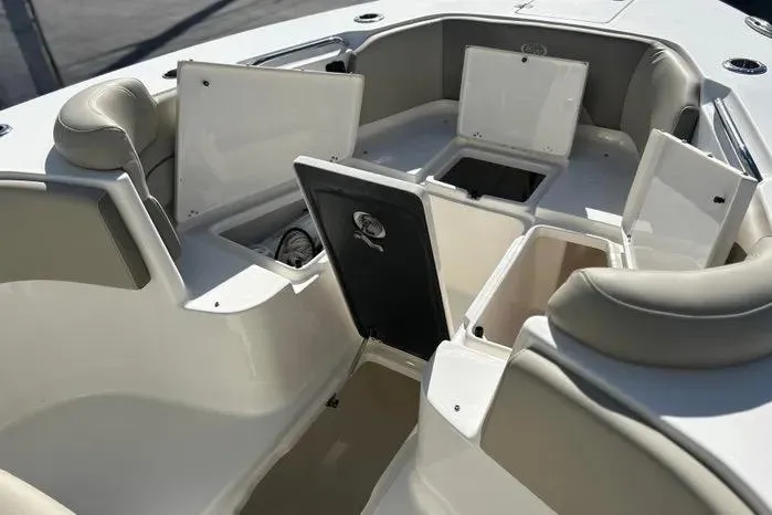 Slide: The Image of 2023 Key West 263 FS boat interior with open storage compartments and seating. - 11