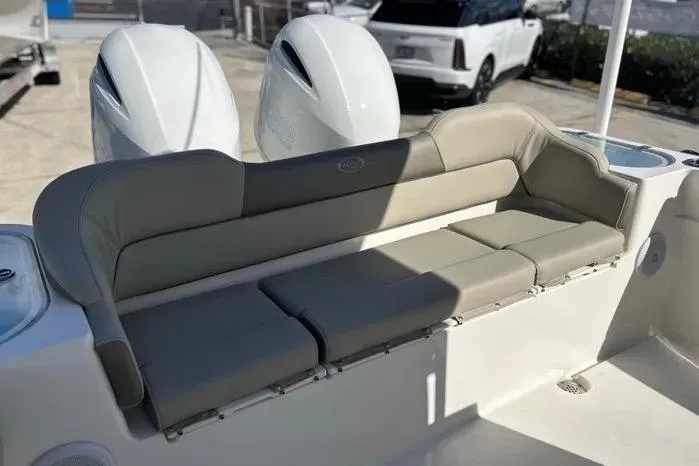 Slide: The Image of 2023 Key West 263 FS boat with cushioned seating and dual outboard motors. - 12