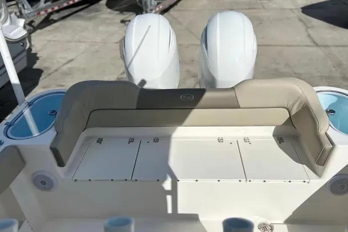 Slide: The Image of 2023 Key West 263 FS boat with dual engines and cushioned seating. - 13