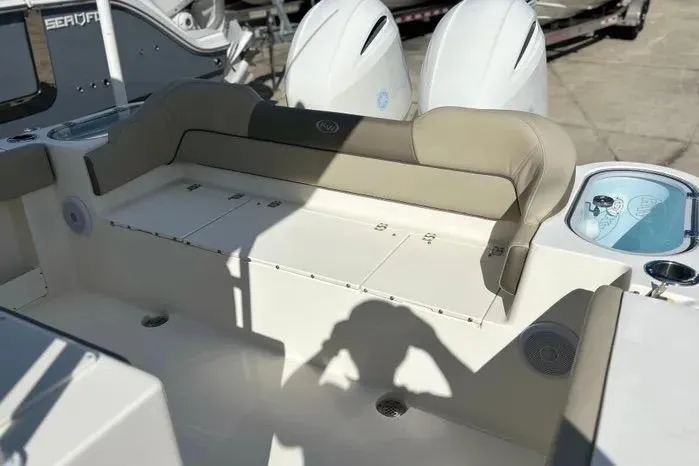 Slide: The Image of 2023 Key West 263 FS boat interior with cushioned seating and dual engines. - 14