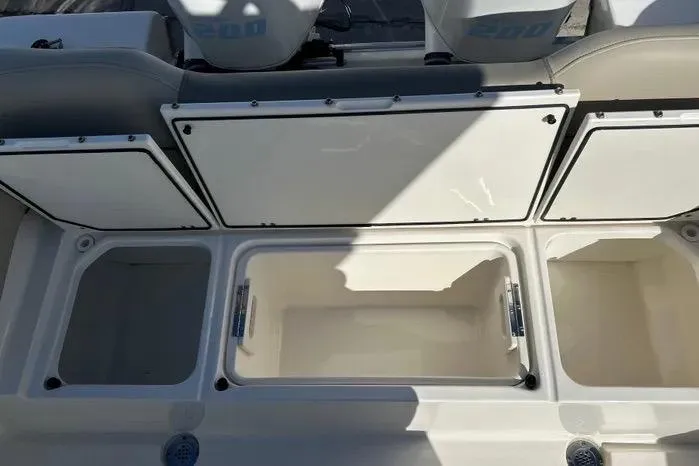 Slide: The Image of 2023 Key West 263 FS boat storage compartments, open and empty, showcasing spacious interior design. - 15