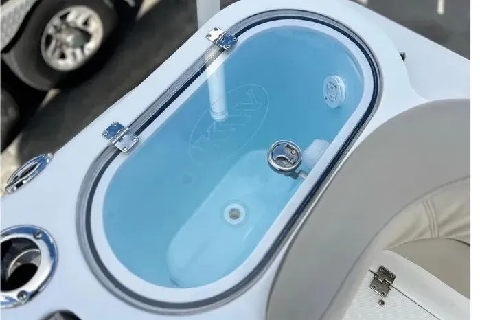 Slide: The Image of 2023 Key West 263 FS boat livewell with clear lid and blue interior. - 18