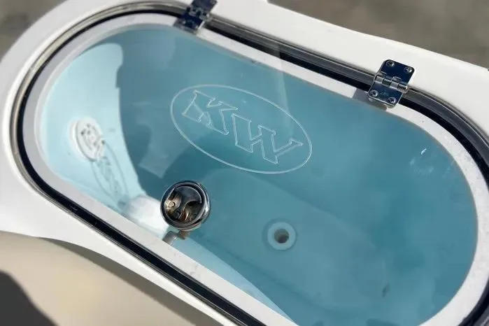 Slide: The Image of Livewell on 2023 Key West 263 FS boat, featuring KW logo and clear lid. - 19