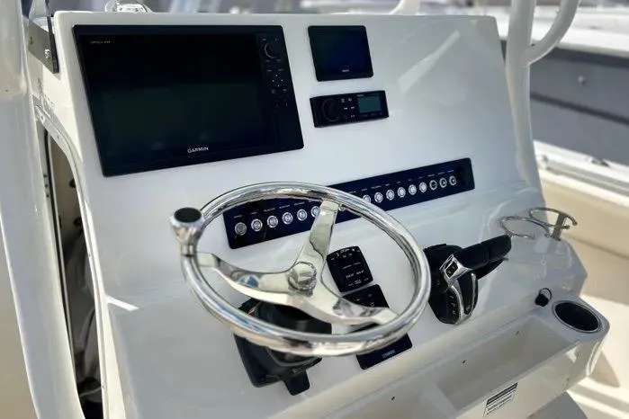 Slide: The Image of 2023 Key West 263 FS boat dashboard with steering wheel and electronic controls. - 22