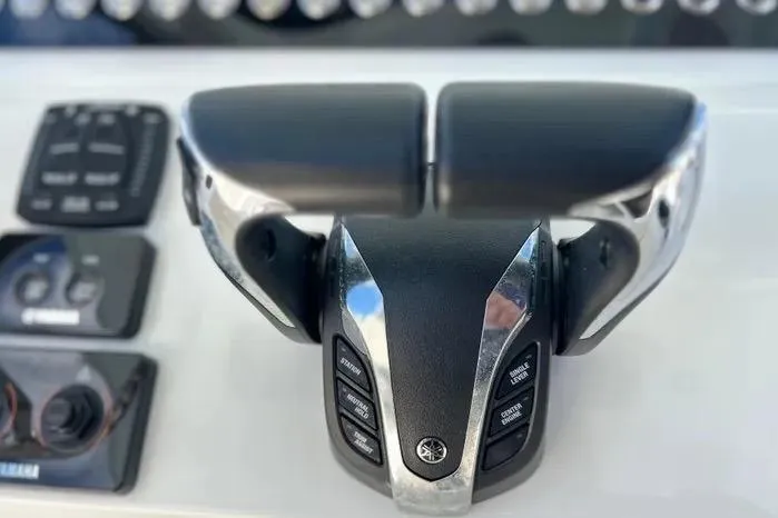 Slide: The Image of Throttle controls on a 2023 Key West 263 FS boat dashboard. - 24
