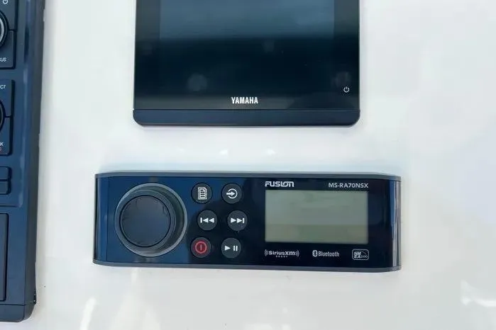 Slide: The Image of Control panel of a 2023 Key West 263 FS boat featuring Yamaha and Fusion systems. - 26