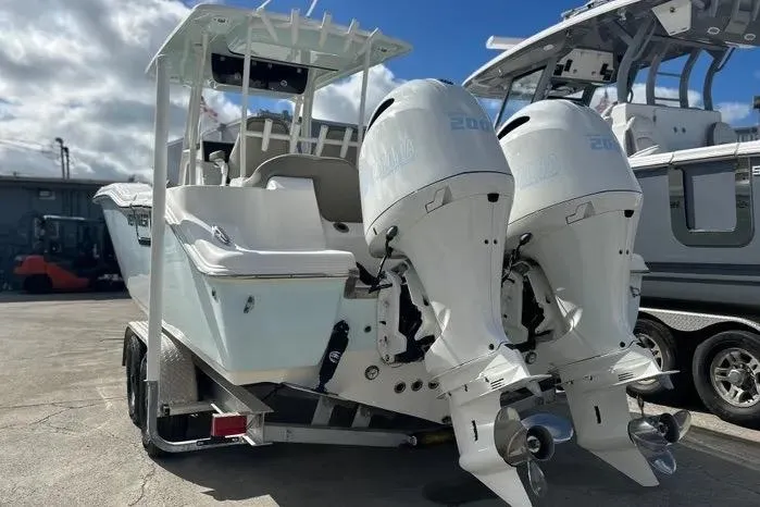 Slide: The Image of 2023 Key West 263 FS boat with dual outboard engines on a trailer. - 3