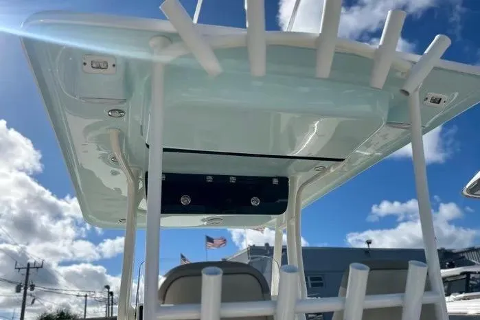 Slide: The Image of 2023 Key West 263 FS boat with T-top and rod holders under a blue sky. - 32