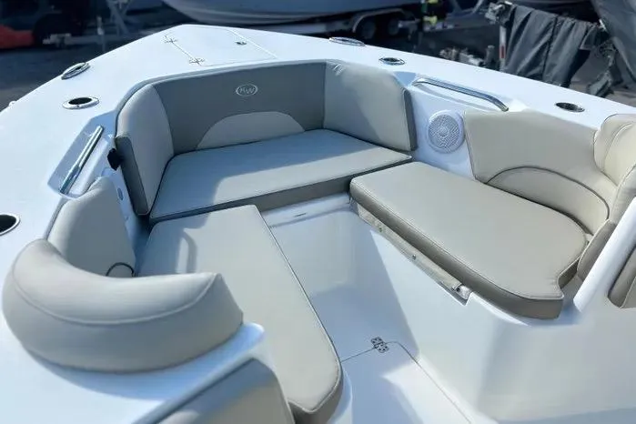 Slide: The Image of 2023 Key West 263 FS boat interior with cushioned seating and speaker system. - 6